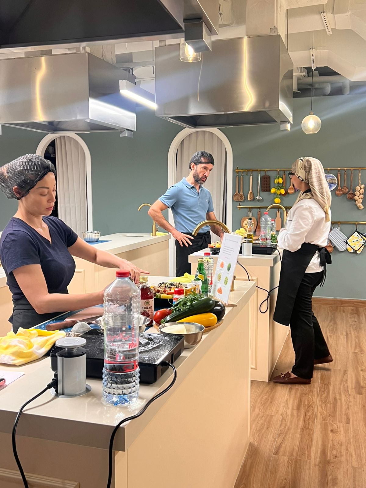 Adults preparing ingredients in the studio kitchen