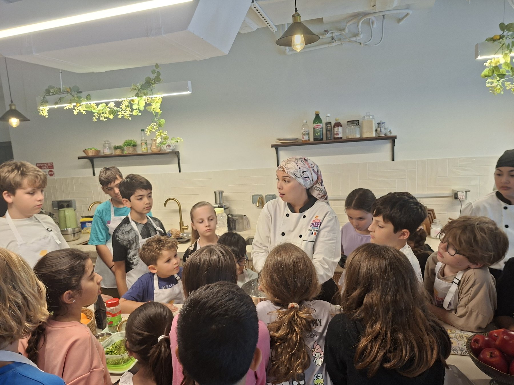 A chef teaching a group of children