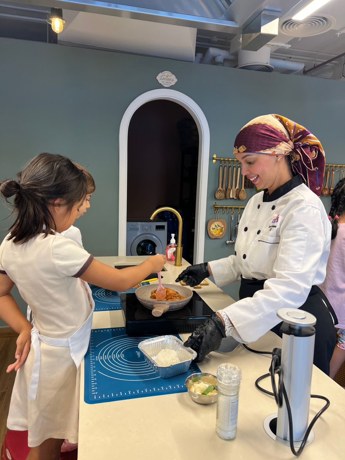 A young student cooking with a chef